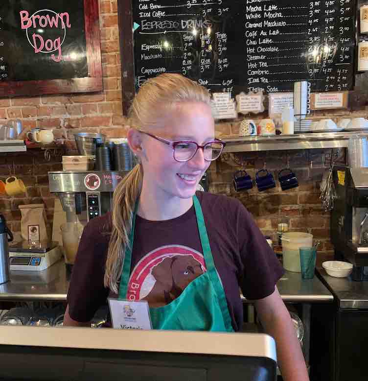 Victoria as cashier at the Brown Dog Cafe