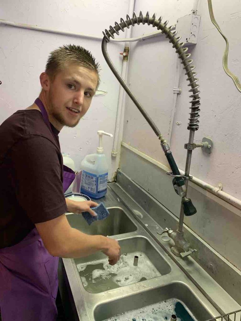 Troy washing dishes at the Brown Dog Cafe